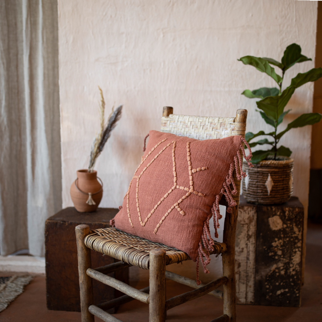 terracotta colored pillow on a chair